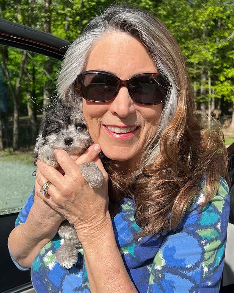 Woman holding a puppy Cavapoo