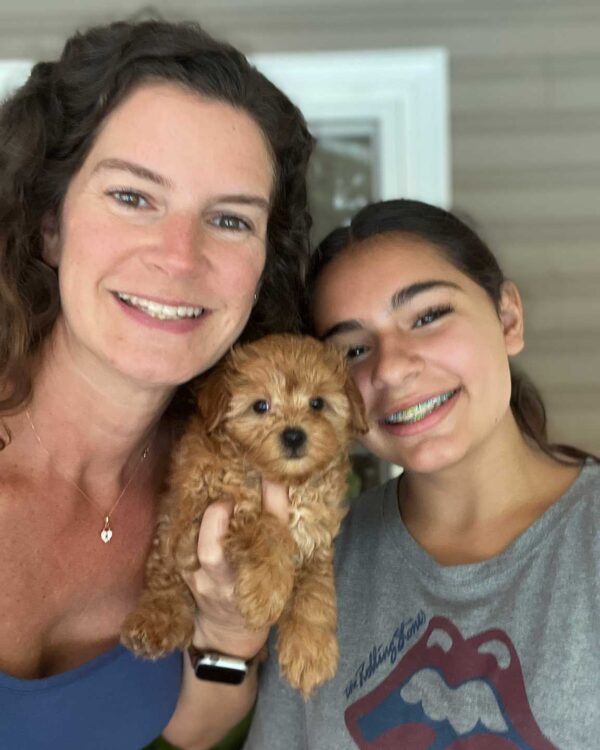 Owner of Jones Farm Puppies an friend holding a Cavapoo puppy