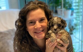 Owner of Jones Farm Puppies holding one of their Cavapoo puppies