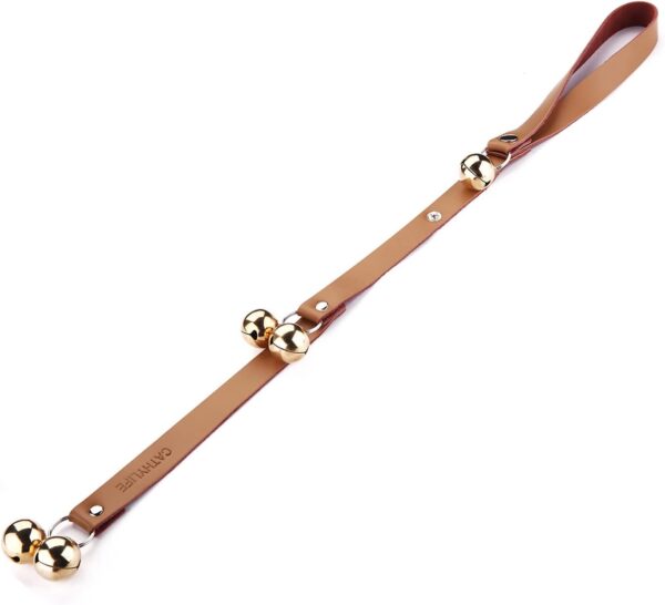 Dog Doorbell. A brown leather strap with a looped handle and several gold jingle bells attached along its length, laid on a white background.